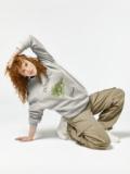 Model posing in a Döbling Vienna sweatshirt with a grapevine design