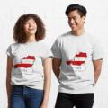 A man and a woman smiling at each other, both wearing matching Austrian flag T-shirts.