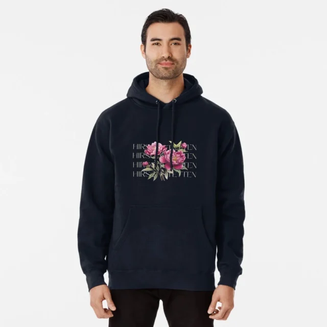 Man wearing a black hoodie with floral design and 'Hirschtetten Vienna' text, casual fashion inspired by Vienna's Hirschtetten neighborhood