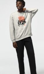 Model wearing Hallstatt-themed sweatshirt with minimalist design