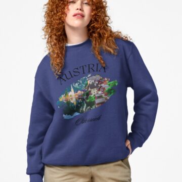 Model wearing a blue sweatshirt with a Hallstatt, Austria graphic design.