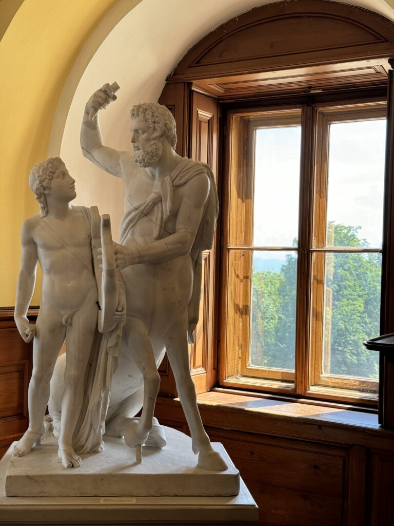 Marble statue of a bearded man with a young boy in Arstetten Castle.