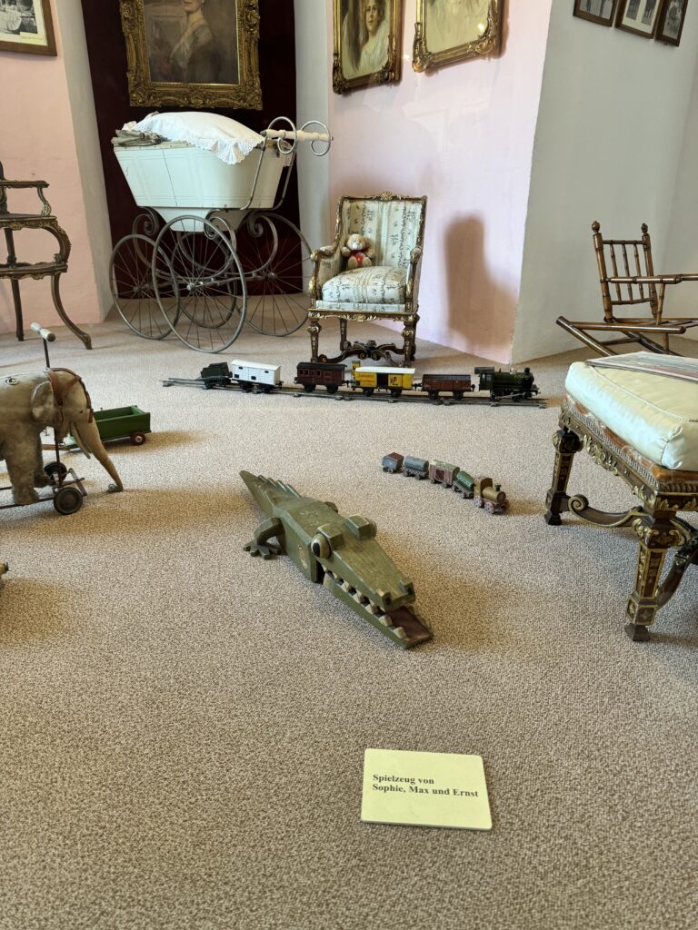 Antique toys including a wooden crocodile and train set on display at Arstetten Castle.