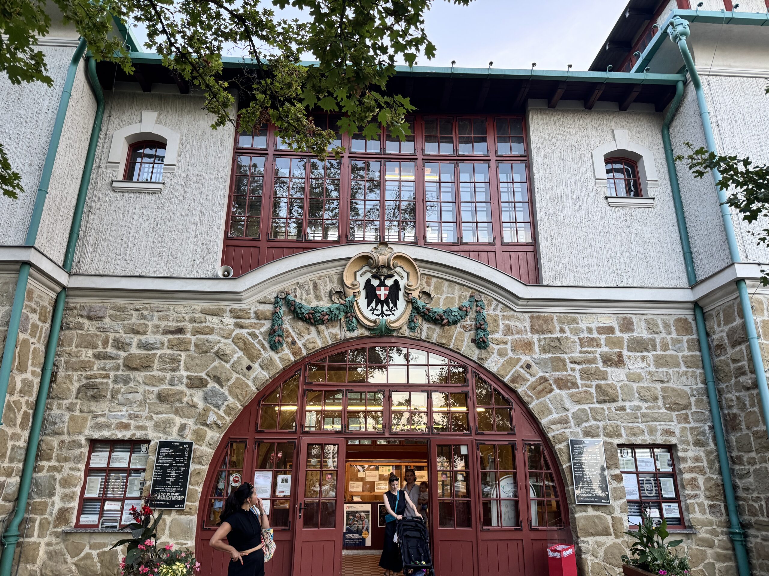 The former Krapfenhütte, now serving as the ticket office and changing rooms at Krapfenwaldbad in Vienna. The building retains its historic charm with its stone facade and traditional architecture.