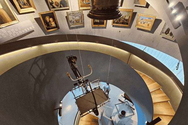 Interior spiral staircase of Paneum museum with art exhibits