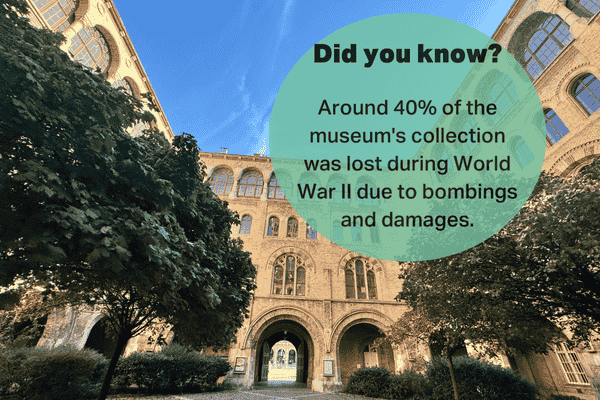 Museum courtyard with historical arches and trees.