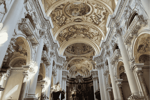 Interior of St. Florian Monastery Church with ornate ceiling frescoes and columns