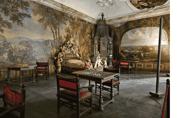 Ornate historical room inside St. Florian Monastery with elaborate furniture and wall paintings