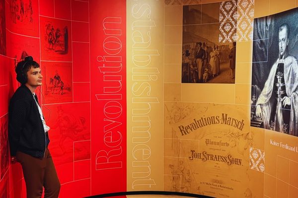 Visitor exploring the "Revolution and Establishment" section at the Johann Strauss Museum in Vienna.