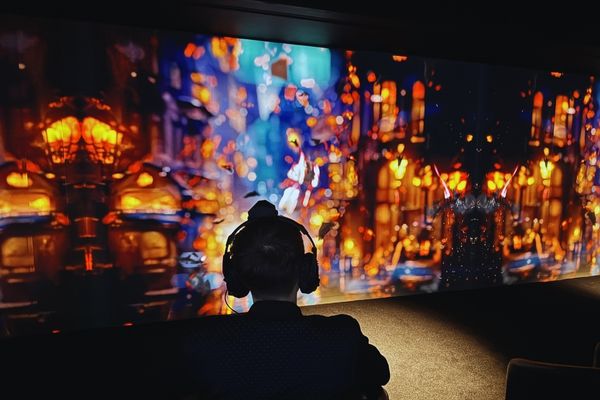 Visitor watching an immersive visual display at the Johann Strauss Museum in Vienna.