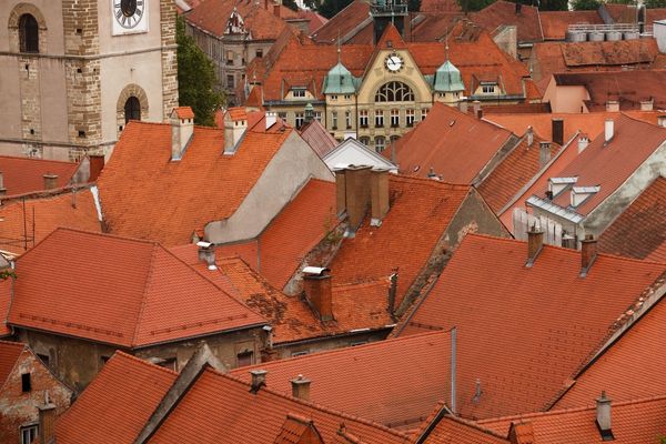 Aerial view of the red rooftops in the old town of Ptuj, Slovenia, showcasing historic buildings and architecture.