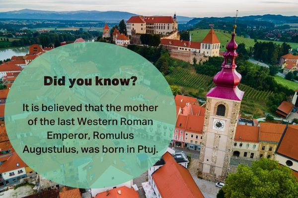 Aerial view of Ptuj, Slovenia, with historic buildings, clock tower, and Ptuj Castle in the background. The image includes a fact about Romulus Augustulus’ mother being born in Ptuj.