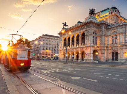 Historic red tram in front of the Vienna State Opera at sunris