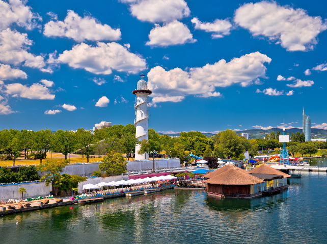 View of Donauinsel in Vienna with lighthouse, floating bars, and blue sky